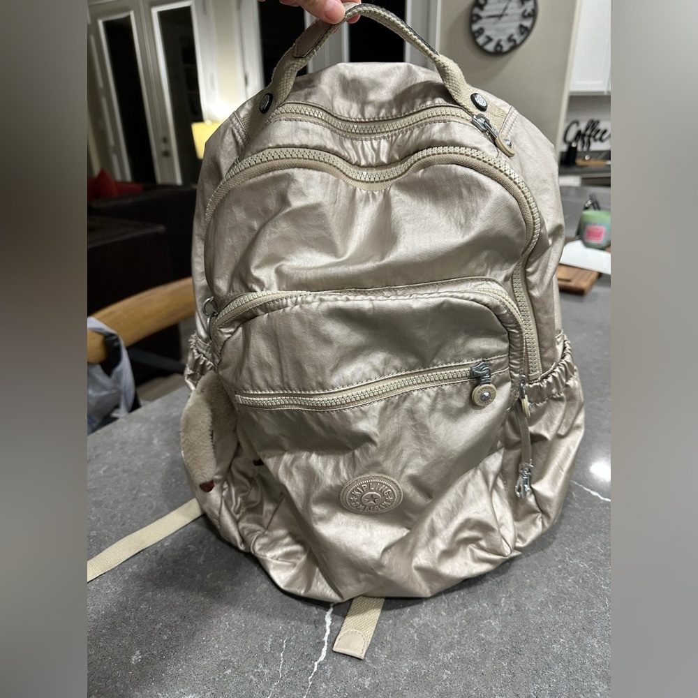 Kipling gold backpack.